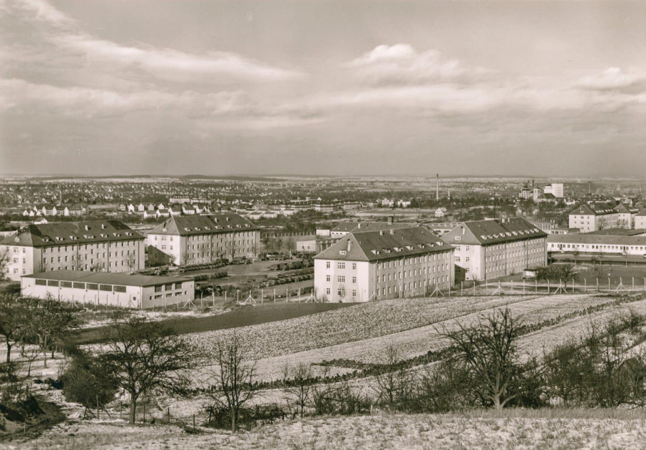 Postwar view over a Displaced Persons camp in Germany, with barracks-style buildings on a hillside